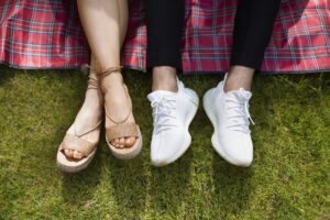 two people in comfortable shoes, only their legs showing, happy and content.